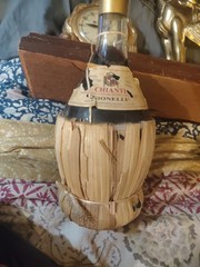 1951 Chianti Melini empty wine bottle, in wicker basket, with import stamp