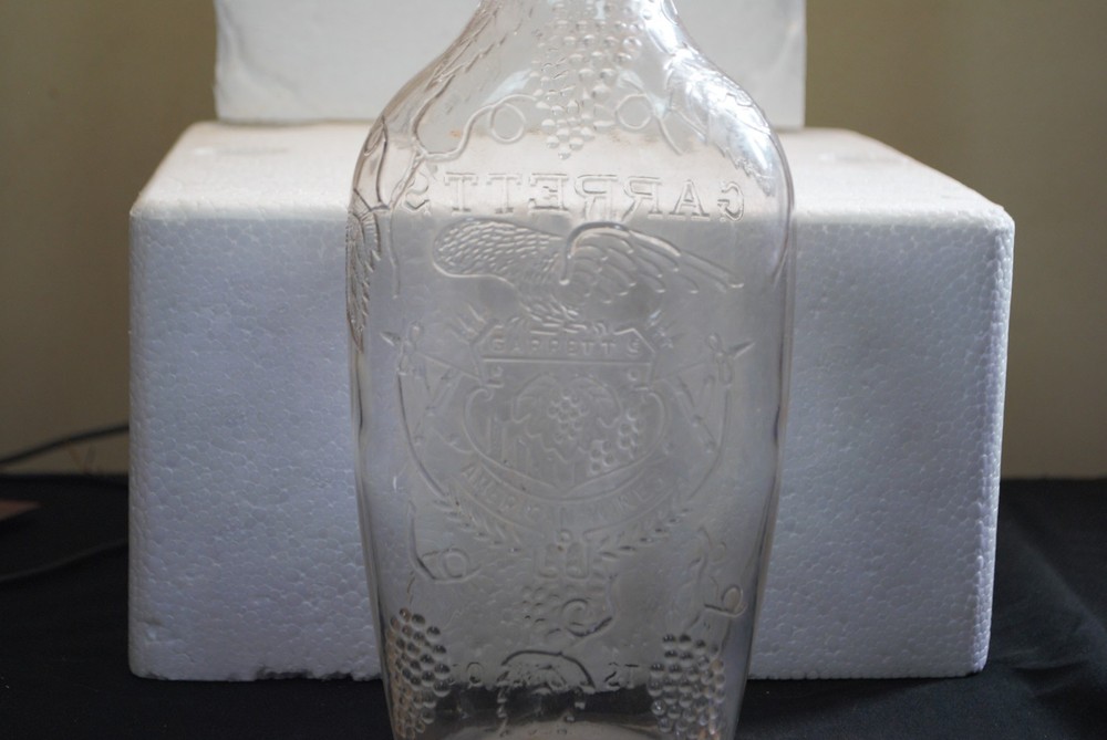 Vintage Garrett&rsquo;s American Wines embossed clear 1 quart wine bottle grapes