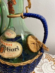 1963 Chianti Italian Wine Green Glass Decanter & Blue Wicker Basket w/labels.