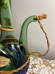 1963 Chianti Italian Wine Green Glass Decanter & Blue Wicker Basket w/labels.
