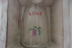 LOVE WINE BOTTLE IN ANTIQUE WHITE BOX. 8 BY 5 BY 4 INCHES.