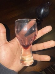 This Is A Vintage Wine Glass and A Bottle The Color Is Is Also Wine Red And Purp