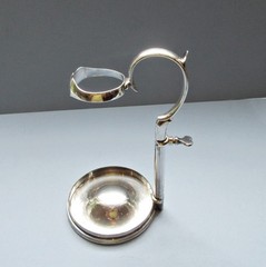 A C1890 silver-plate wine bottle holder by Hukin & Heath,