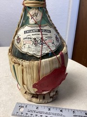 1951 Chianti Melini empty wine bottle, in wicker basket, with import stamp