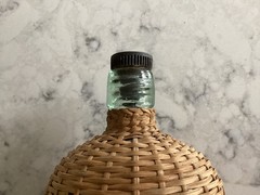 Vintage Coracle Green Glass Wicker Wrapped Bottle ( 9 inches tall )