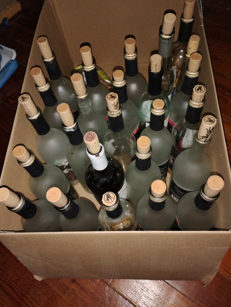 24 ish empty wine bottles and extra corks