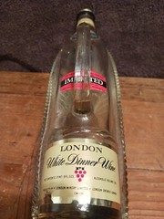 Vintage LONDON WINERY LTD Empty Clear Horizontal Bottle in Basket/Ship w/Handle