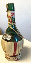 1951 Chianti Melini empty wine bottle, in wicker basket, with import stamp