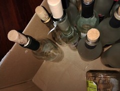 24 ish empty wine bottles and extra corks