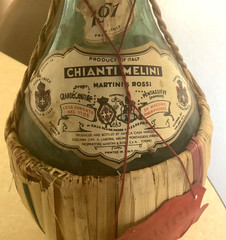 1951 Chianti Melini empty wine bottle, in wicker basket, with import stamp