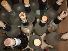 24 ish empty wine bottles and extra corks