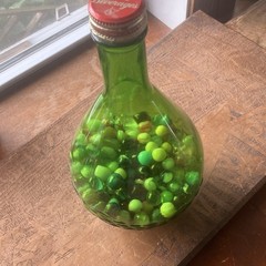 Green Glass Wine Bottle with Cap, Filled with Assorted vintage Marbles Inside