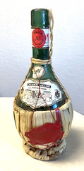 1951 Chianti Melini empty wine bottle, in wicker basket, with import stamp