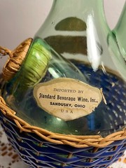 1963 Chianti Italian Wine Green Glass Decanter & Blue Wicker Basket w/labels.