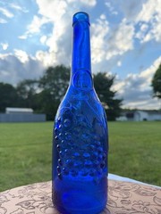 Vintage AM Cobalt Blue Glass Wine Bottle with Embossed Grapes and Leaves