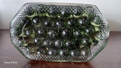 Vintage Glass Wine Bottle With Embossed Design Full of Green Marbles