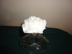 JNSQ Rose CRU glass bottle with white rose stopper, 10” tall, 5.75” wide. EMPTY