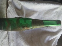 old German green wine bottle with gold embossed monkey wrapped around it