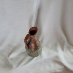 Empty wine bottle in the style of ancient Greece with a basket weave texture and