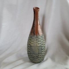Empty wine bottle in the style of ancient Greece with a basket weave texture and