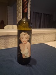Marilyn Monroe Merlot wine bottle, adorned with beaded bottle cover.