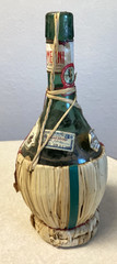 1951 Chianti Melini empty wine bottle, in wicker basket, with import stamp