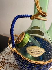 1963 Chianti Italian Wine Green Glass Decanter & Blue Wicker Basket w/labels.