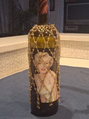 Marilyn Monroe Merlot wine bottle, adorned with beaded bottle cover.