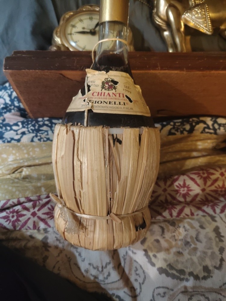 1951 Chianti Melini empty wine bottle, in wicker basket, with import stamp