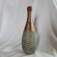 Empty wine bottle in the style of ancient Greece with a basket weave texture and