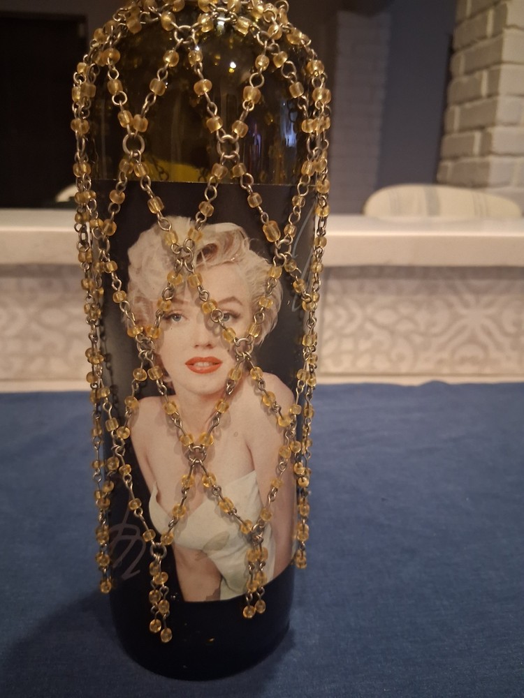 Marilyn Monroe Merlot wine bottle, adorned with beaded bottle cover.