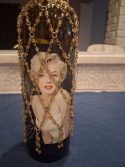 Marilyn Monroe Merlot wine bottle, adorned with beaded bottle cover.