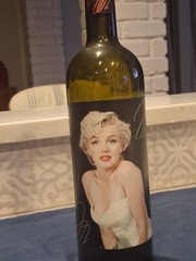 Marilyn Monroe Merlot wine bottle, adorned with beaded bottle cover.