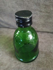 WIne World Vintage Small Green Glass Bottle 1976 embossed grapes screw top cap