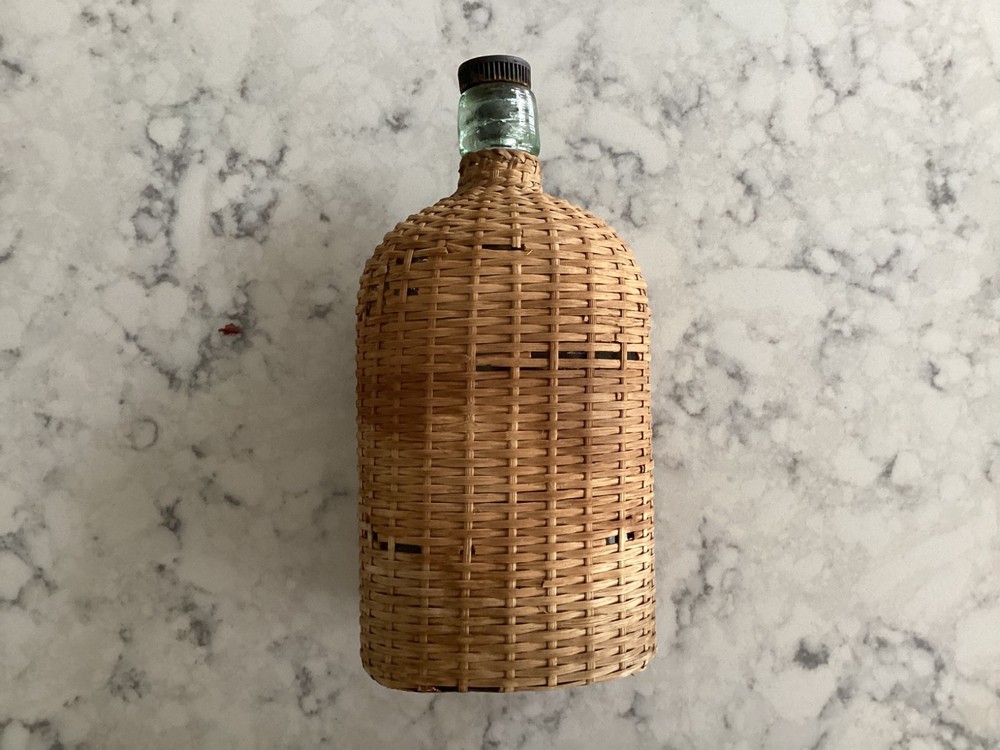 Vintage Coracle Green Glass Wicker Wrapped Bottle ( 9 inches tall )