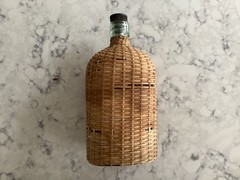 Vintage Coracle Green Glass Wicker Wrapped Bottle ( 9 inches tall )
