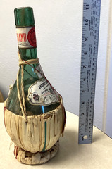 1951 Chianti Melini empty wine bottle, in wicker basket, with import stamp
