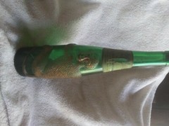 old German green wine bottle with gold embossed monkey wrapped around it
