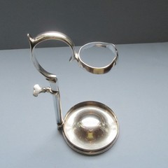 A C1890 silver-plate wine bottle holder by Hukin & Heath,