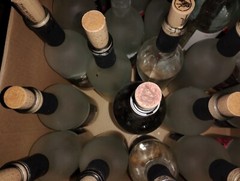 24 ish empty wine bottles and extra corks