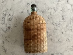 Vintage Coracle Green Glass Wicker Wrapped Bottle ( 9 inches tall )