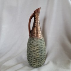 Empty wine bottle in the style of ancient Greece with a basket weave texture and