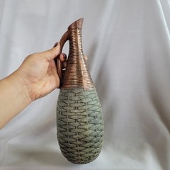 Empty wine bottle in the style of ancient Greece with a basket weave texture and