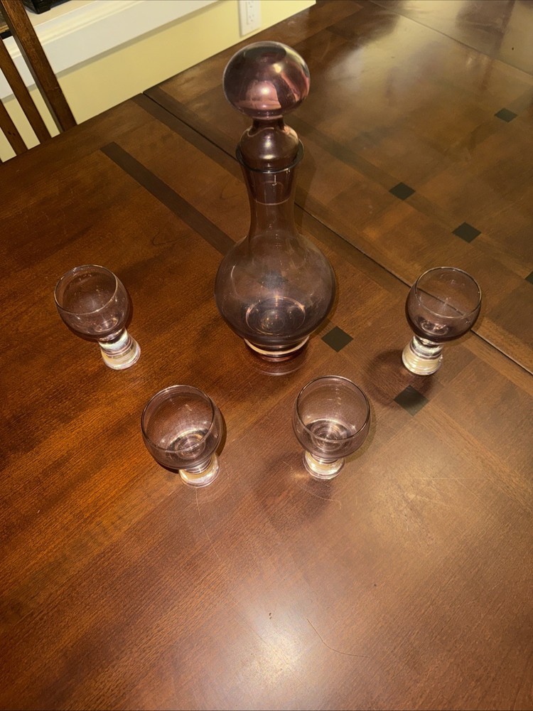 This Is A Vintage Wine Glass and A Bottle The Color Is Is Also Wine Red And Purp